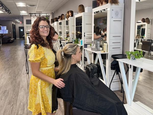 Jayme performing layered haircut with face-framing technique at Naples hair salon